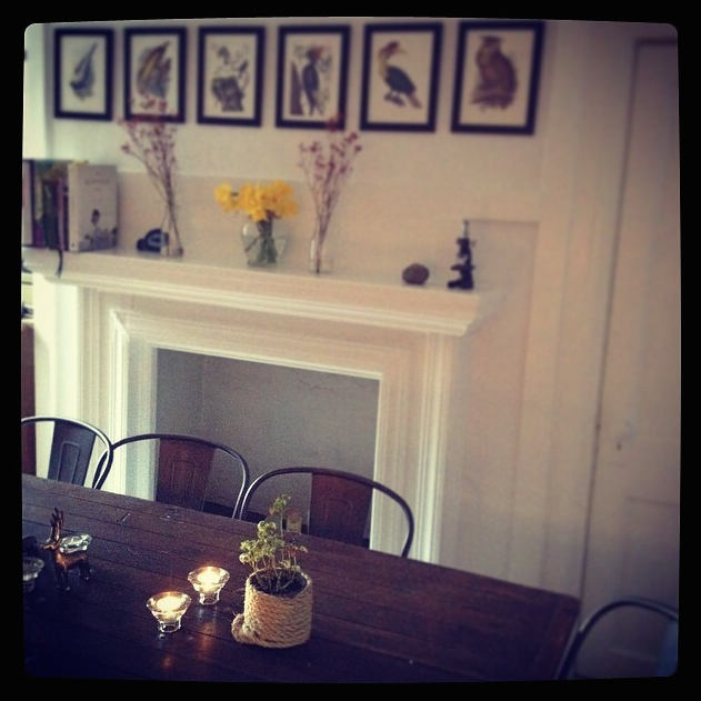 Dining table. Daytime. Fresh flowers and Kinfolk cookbook in background.